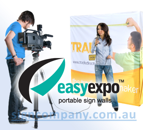 TV Interview backdrop sign with logo. Girl reporter with camera man and sign